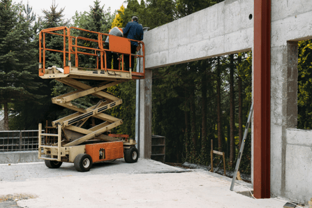 Operator safely working on MEWP scissor lift during NPORS N109 training session