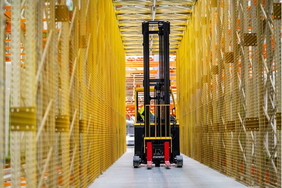 Operator training on narrow aisle lift truck in confined warehouse space during NPORS N007 course