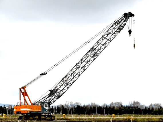 Certified operator controlling a CPCS A02 crawler crane above 10 tonnes on a construction site