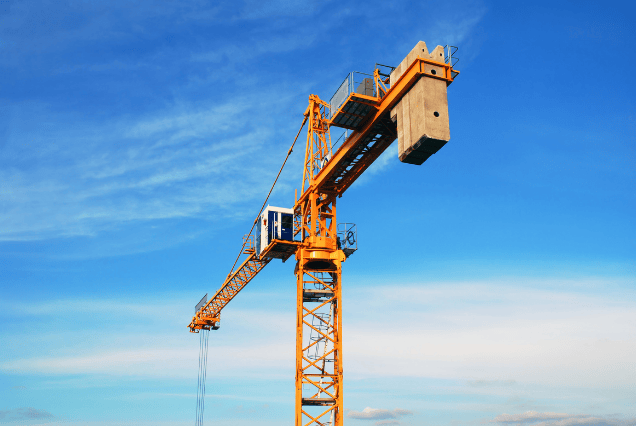 Operator managing remote controlled tower crane during CPCS A04c training on a construction site