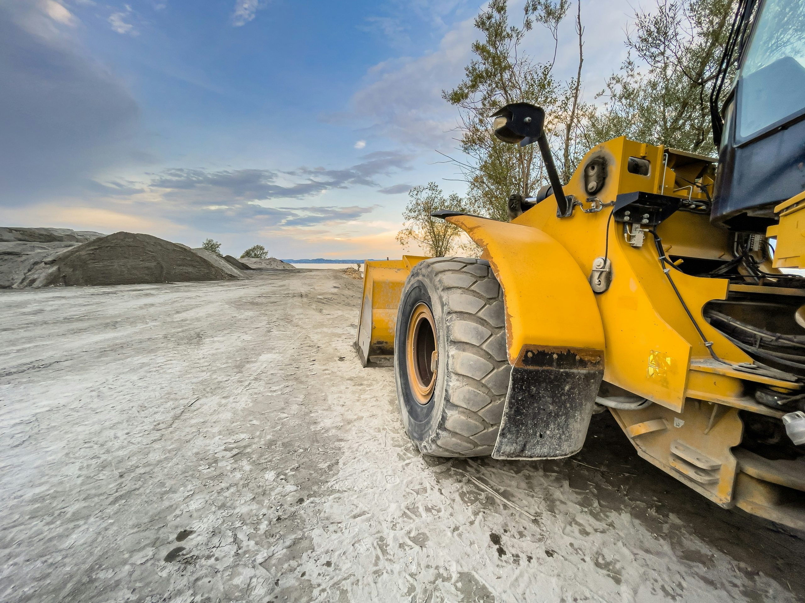 Close-up of loading shovel scooping material during NPORS N209 training course