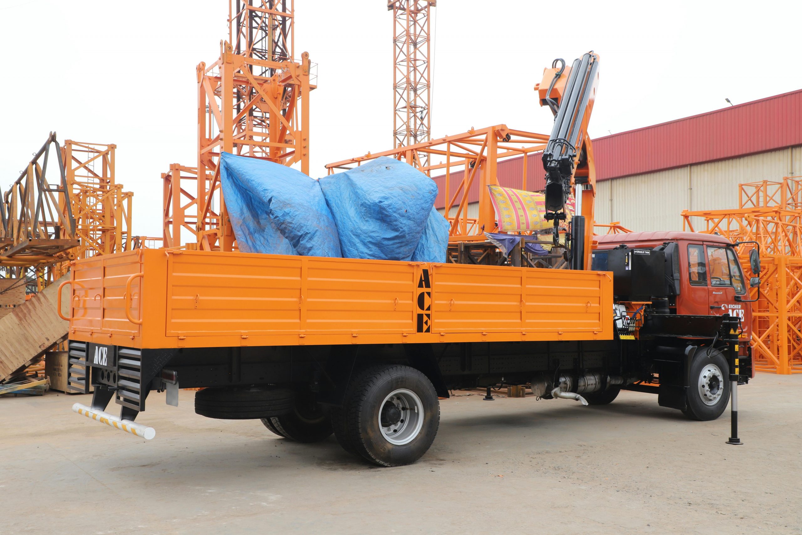 Operator using lorry loader crane to lift materials on site during NPORS N107 training