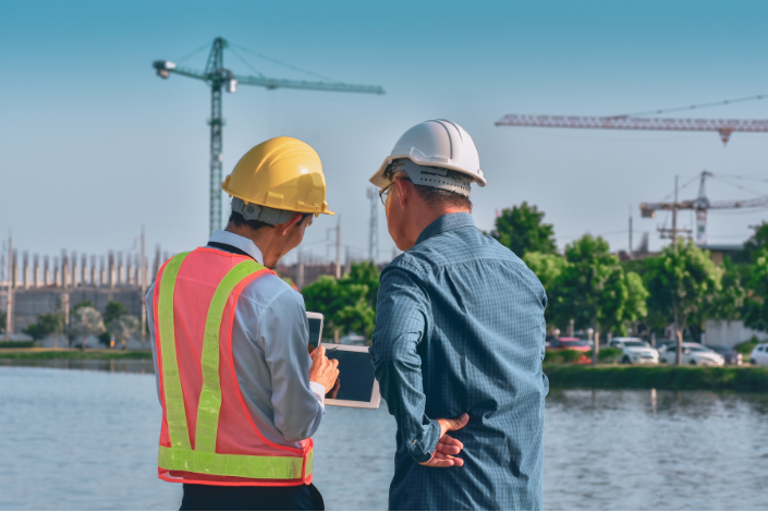 Construction site supervisor overseeing operations during NVQ Level 3 Occupational Supervisor training