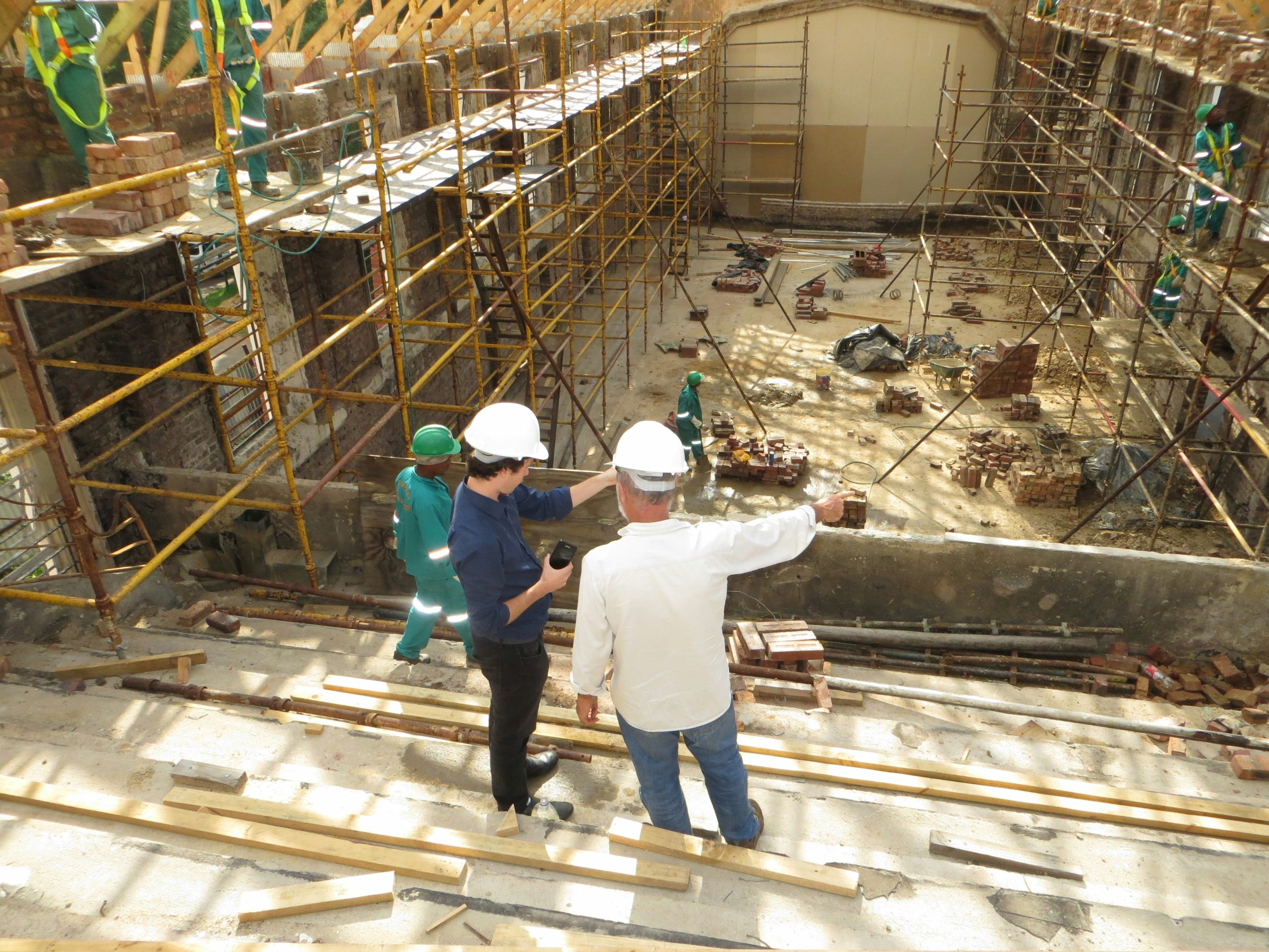Construction site safety manager overseeing site operations after completing NPORS S032 refresher course